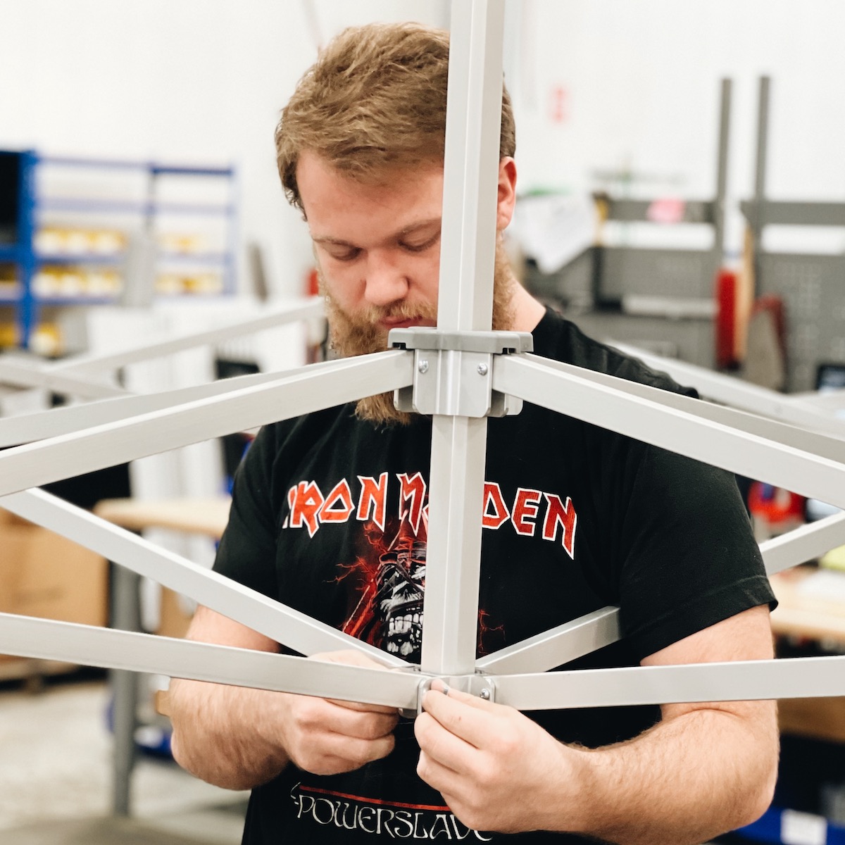 TentCraft employee assembling a MONARCHTENT frame