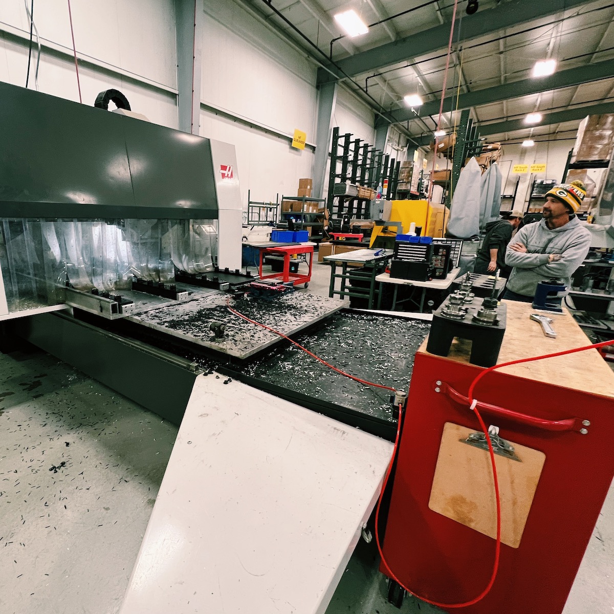 TentCraft employee works a machine to fabricate metal for pop-up tent frames.