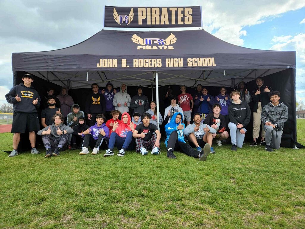 A track team under a custom printed tent