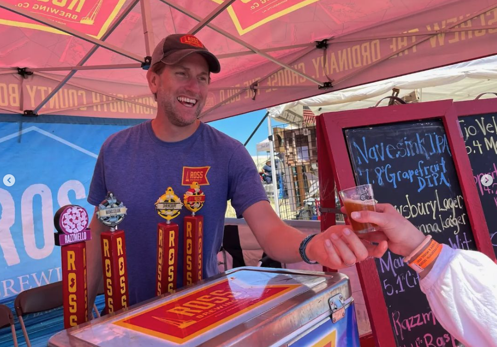 Ross Brewing Co. employees stand in front of their custom brewery tent.