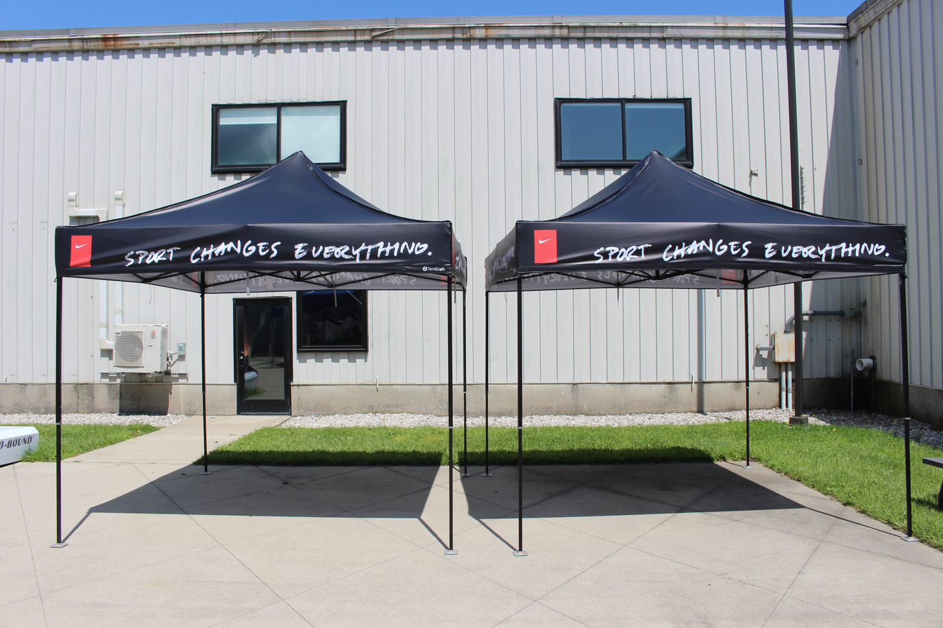 side by side black printed popup tents