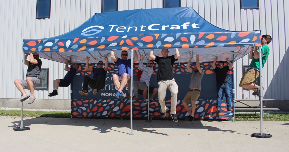 9 people hanging from a heavy duty pop-up canopy