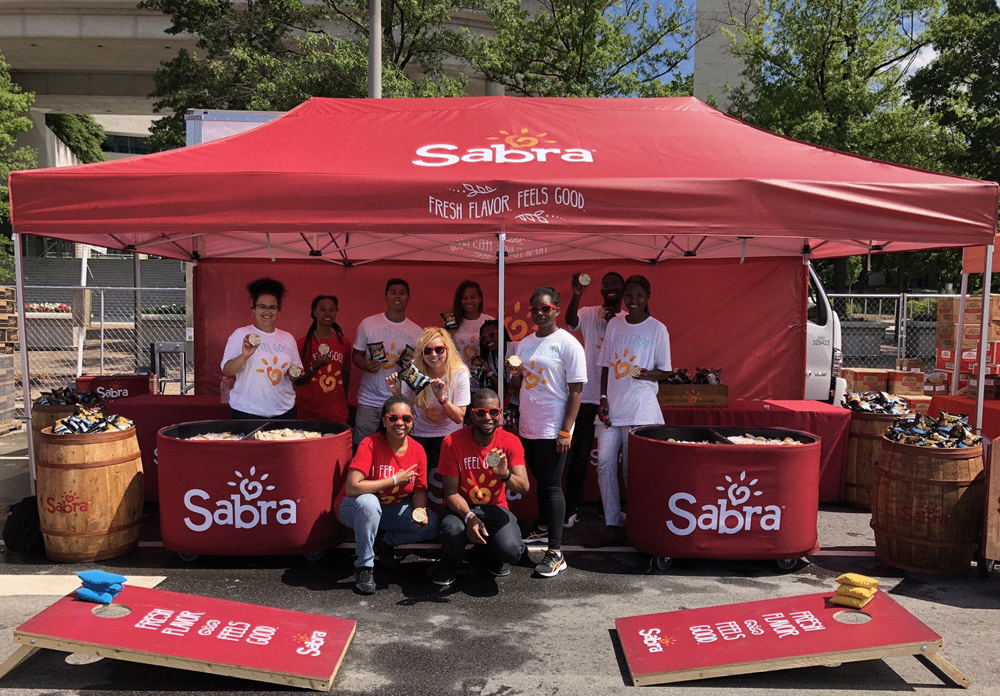 10x20 pop-up tent with Sabra branding that includes matching walls, corn hole games and sampling team.