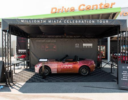 A custom truss event structure with roof providing shelter for a classic car.