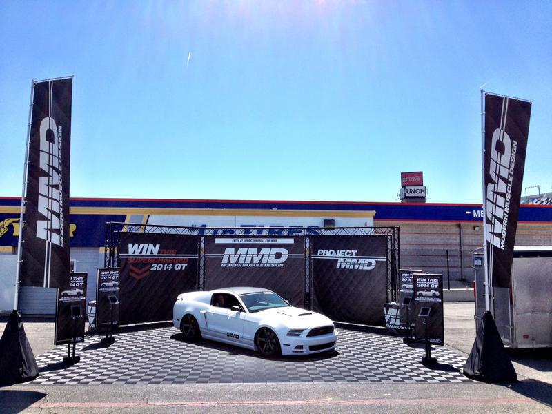 custom printed truss walls and large printed flags at outdoor car event