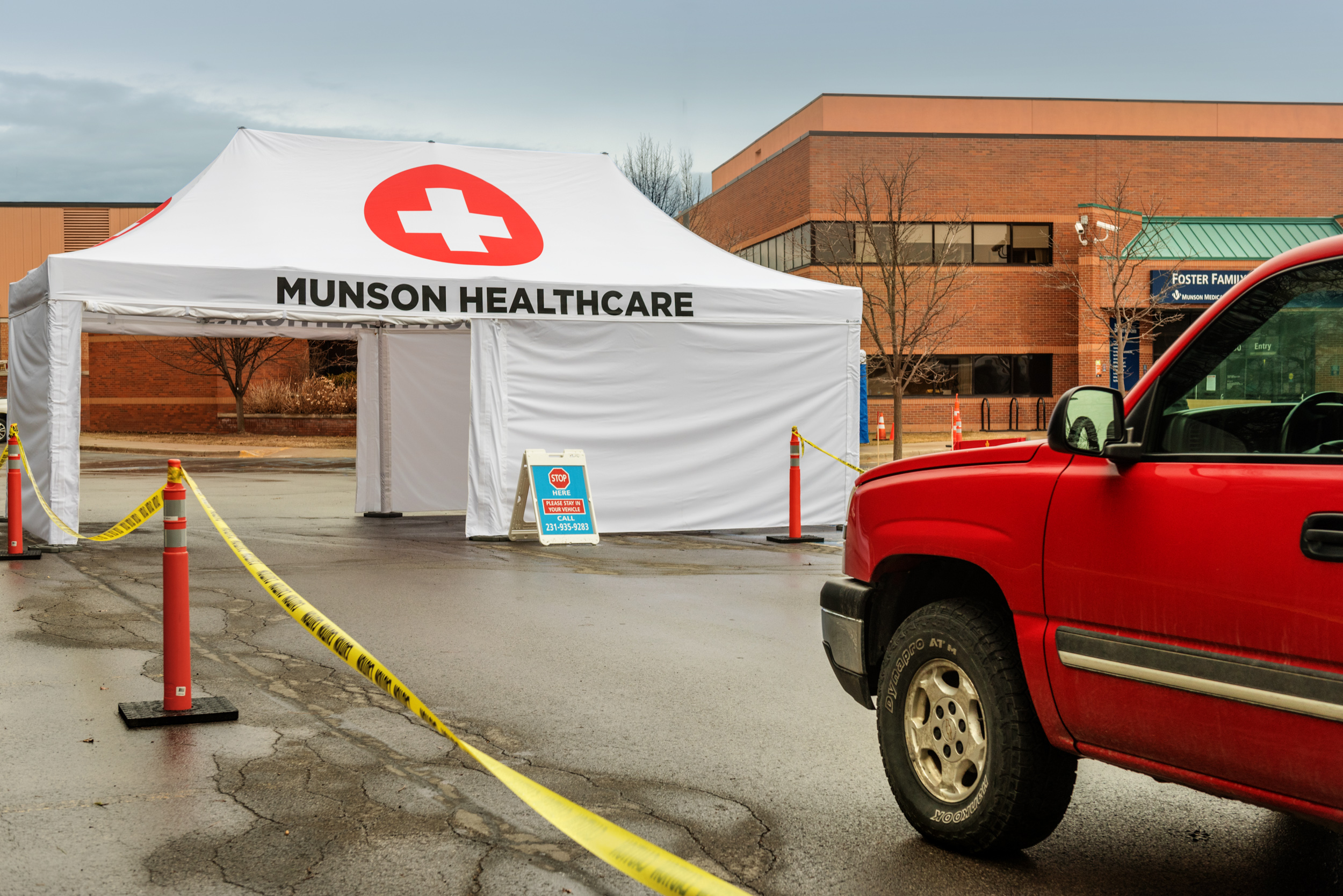 A custom-printed screening-tent being used to check for coronavirus symptoms at Munson Medical Center