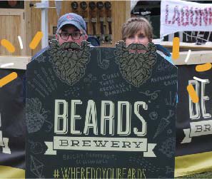 Two beer festival participants using custom printed A-frame stand at festival.