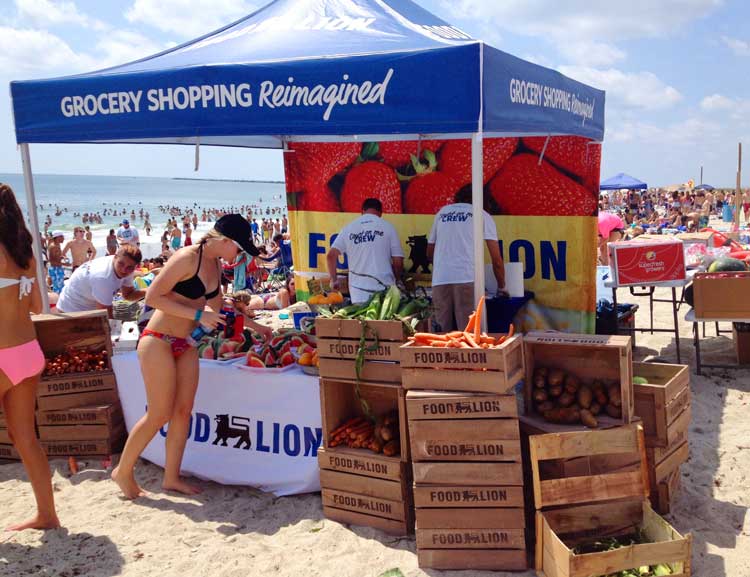 A 10x10 heavy-duty pop-up tent with UV printed full back wall used at beach for snack tent.