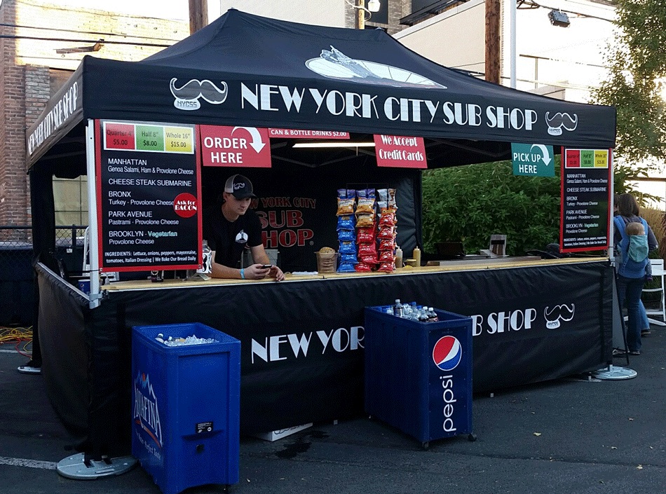 A 10x15 heavy-duty pop-up tent with full, half walls and countertops used for food concessions for a New York City Sub Shop